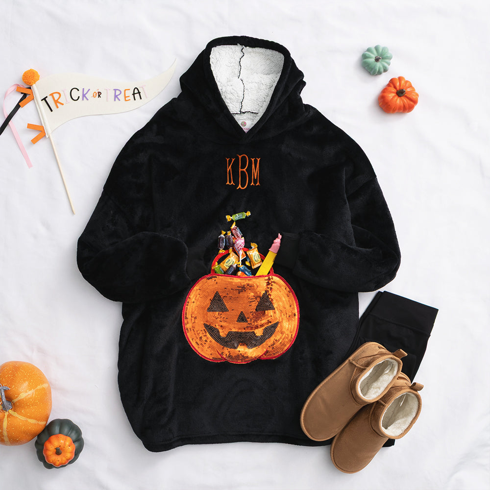 pumpkin blanket hoodie flatlay with candy