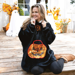 pumpkin blanket hoodie on emily sitting on porch