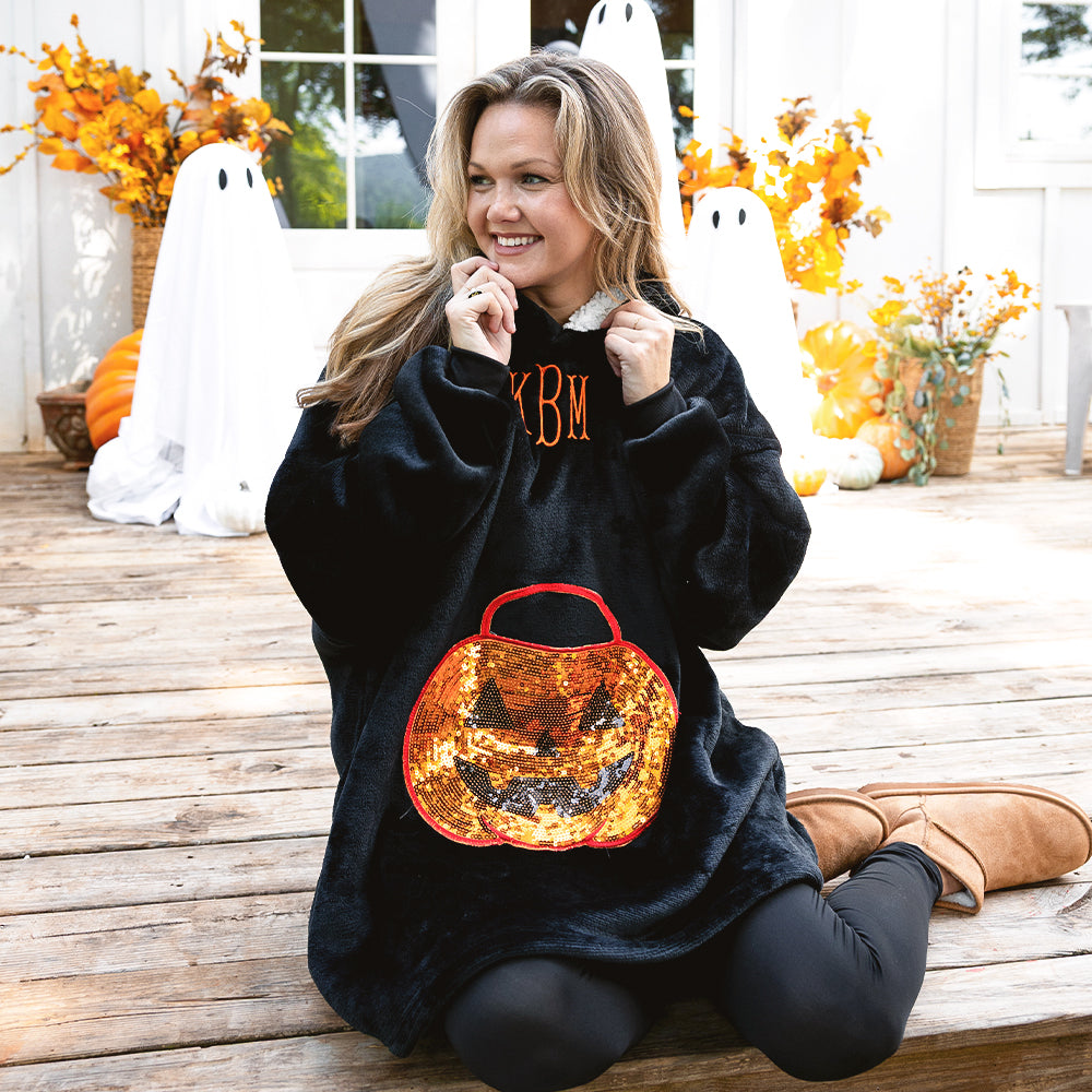 pumpkin blanket hoodie on emily sitting on porch