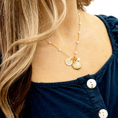 shell pearl necklace on neck