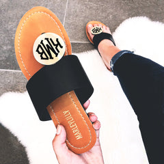 black monogrammed sandals selfie
