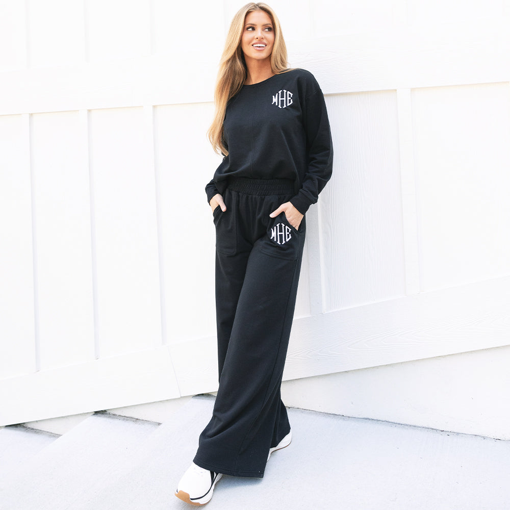 monogrammed black wide leg pants with sneakers