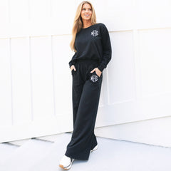 monogrammed black wide leg pants with sneakers