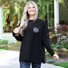 black crewneck sweatshirt on blonde girl by cabin