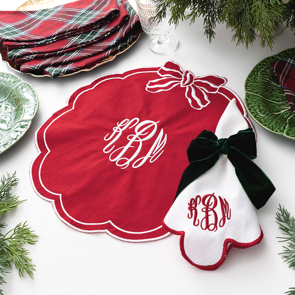 red bow scallop placemat with napkin and bow napkin holders