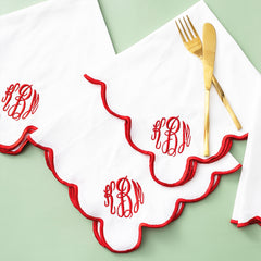 red scalloped napkins on green