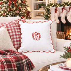red scalloped pillow sham on couch christmas scene