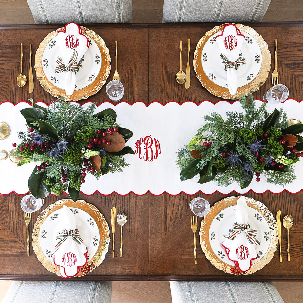 red scalloped table runner and christmas settings from above