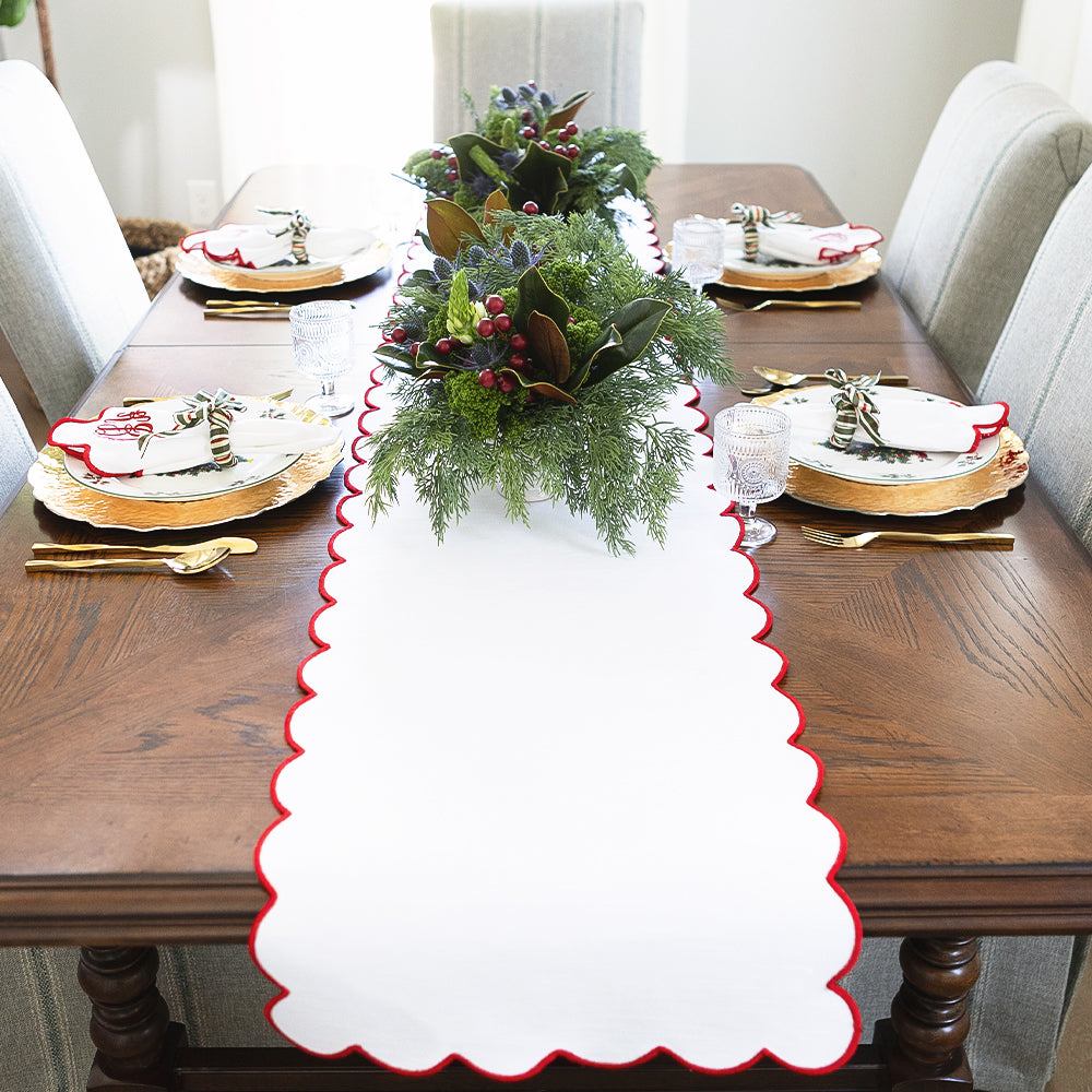 red scalloped table runner and christmas settings