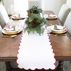red scalloped table runner and christmas settings