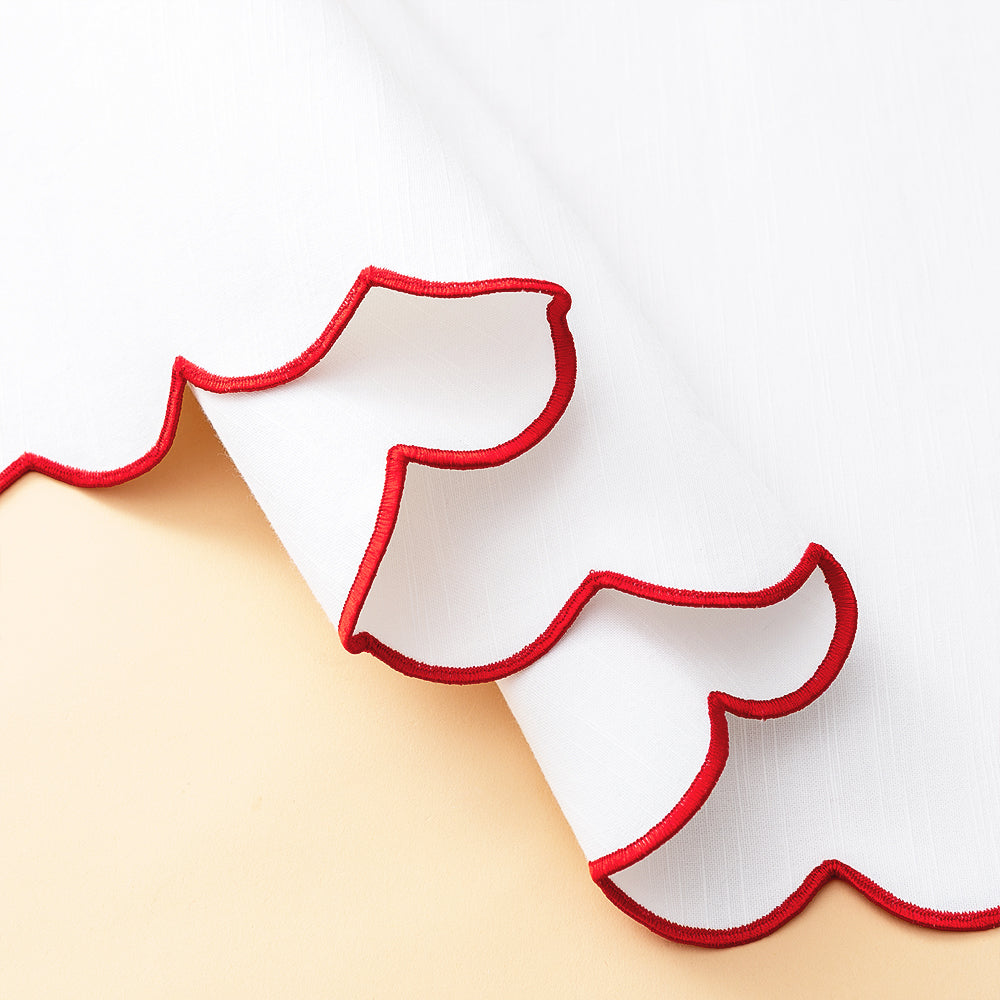 red scalloped table runner detail shot scallop