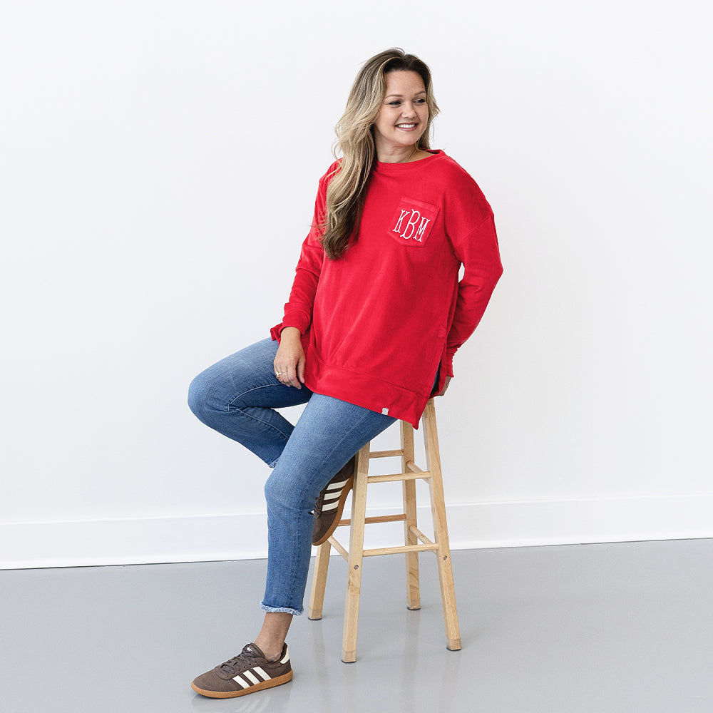 red softspun sweatshirt on girl sitting on stool