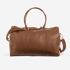 leather Monogrammed Weekender sitting behind mens clothes and shoes