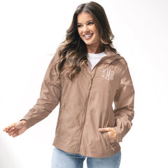 girl wearing acorn lightweight monogrammed rain jacket