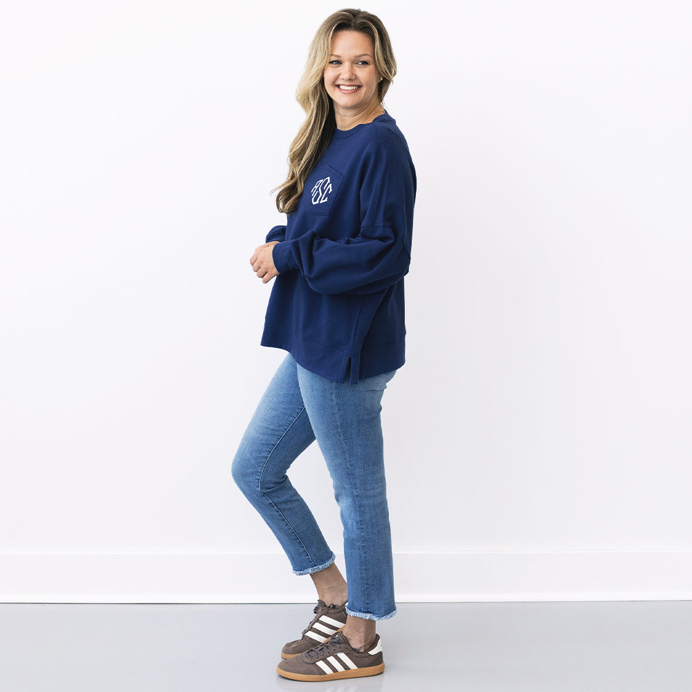 side of girl wearing monogrammed oversized sweatshirt in navy 