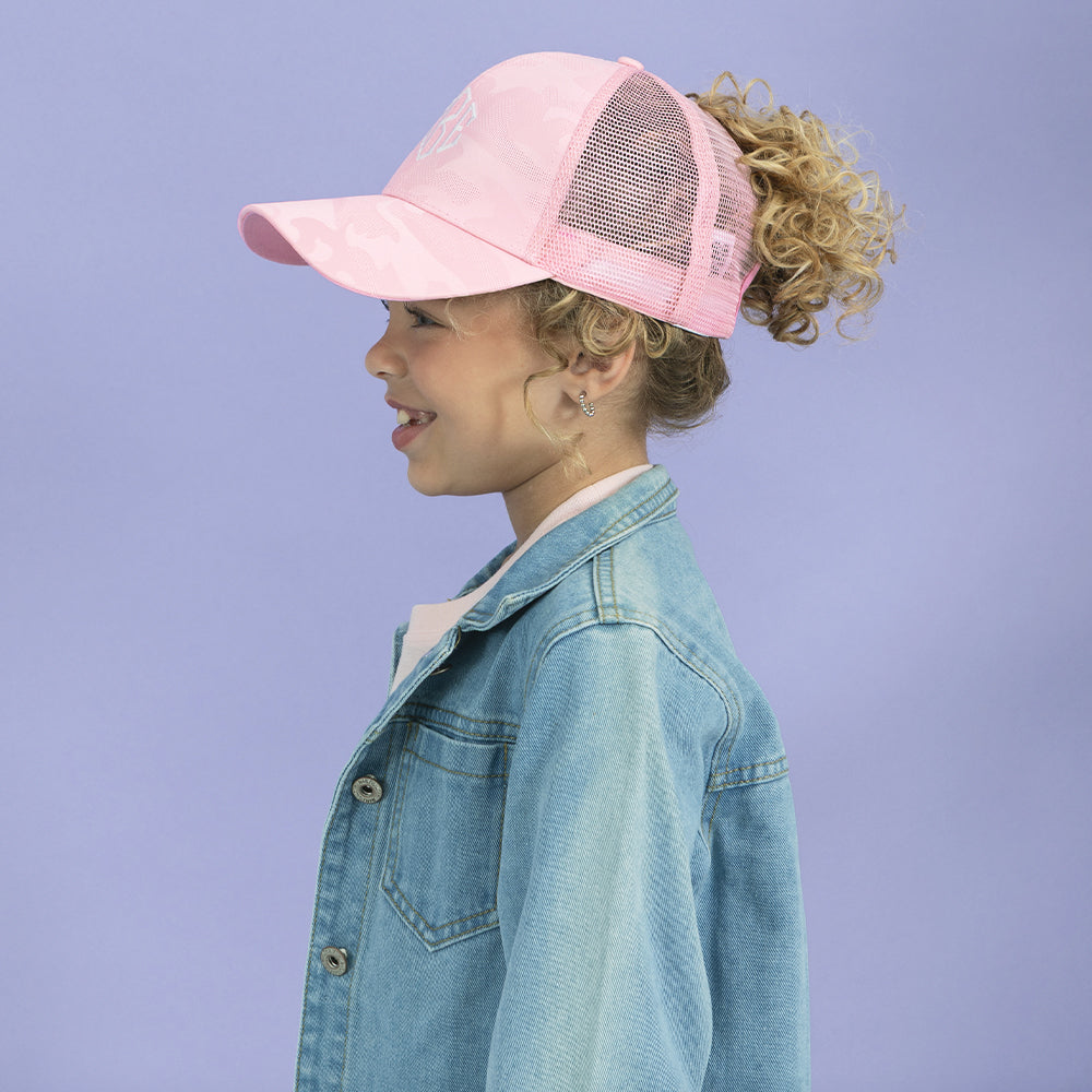 side of girl wearing pink camo trucker hat 