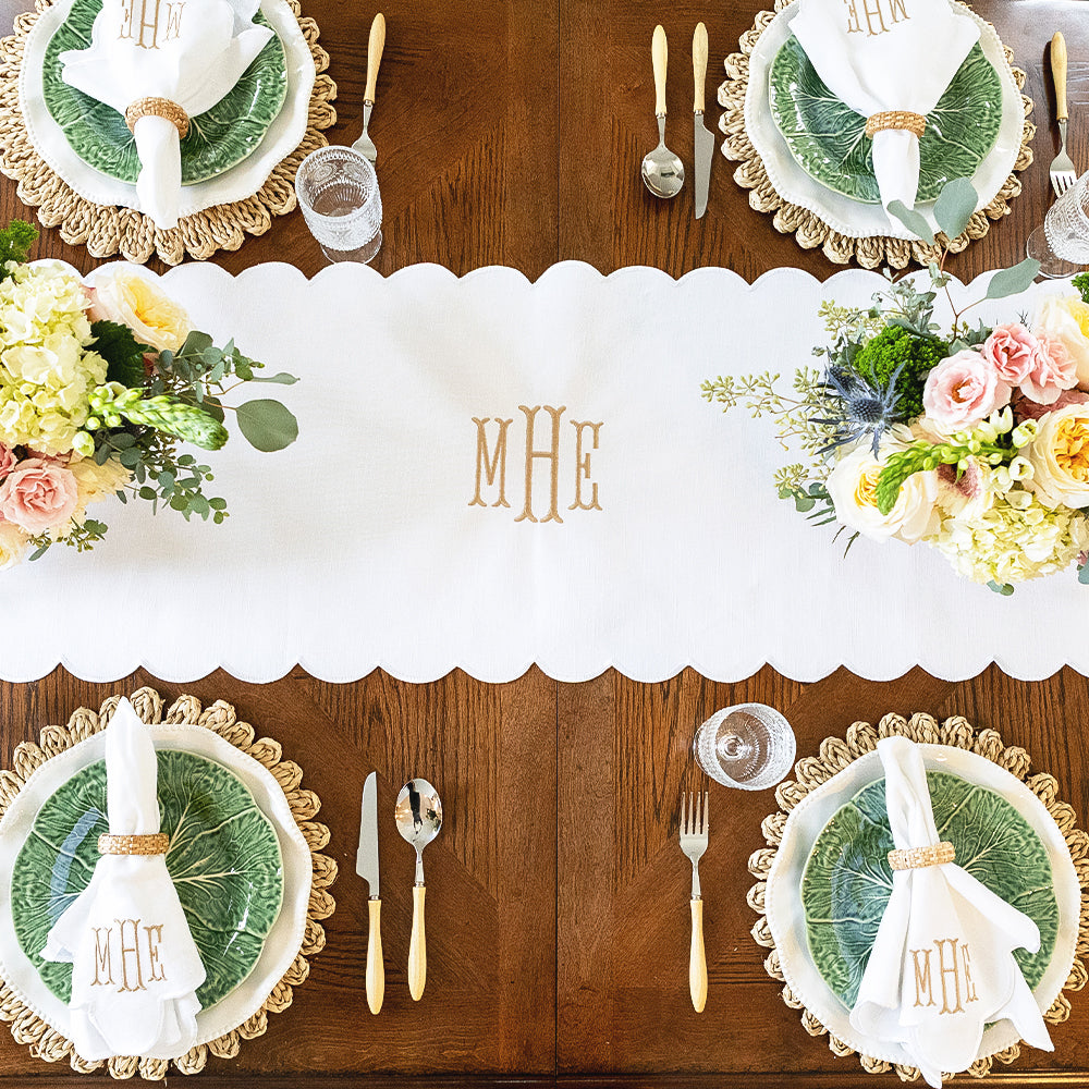 white scalloped table runner on table with settings
