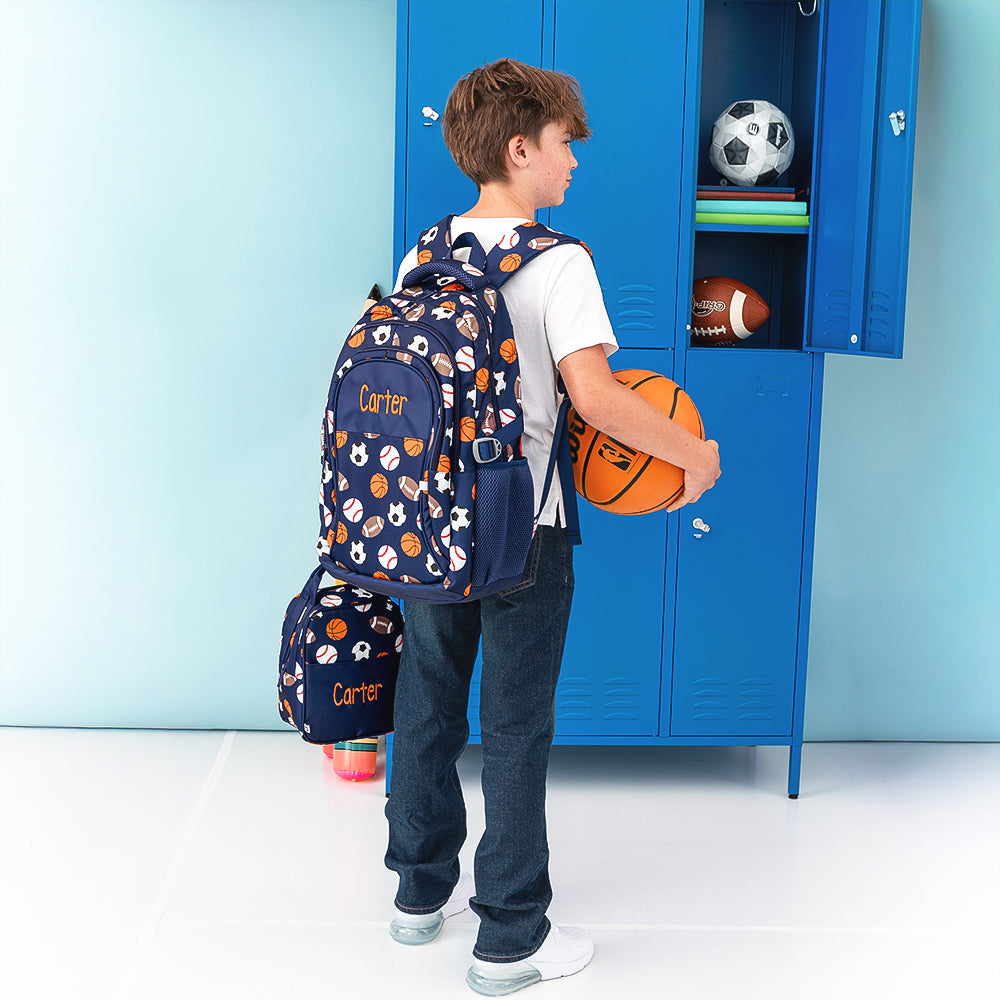 sports balls backpack on boy holding basketball 