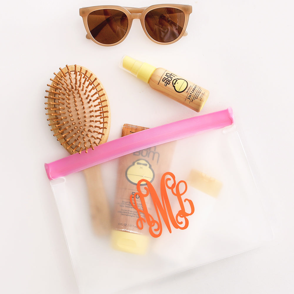 sunscreen in pink airtight monogrammed bag