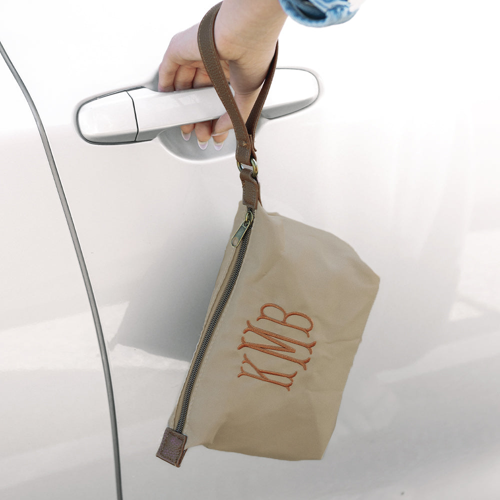 tan monogrammed lightweight wristlet and car 