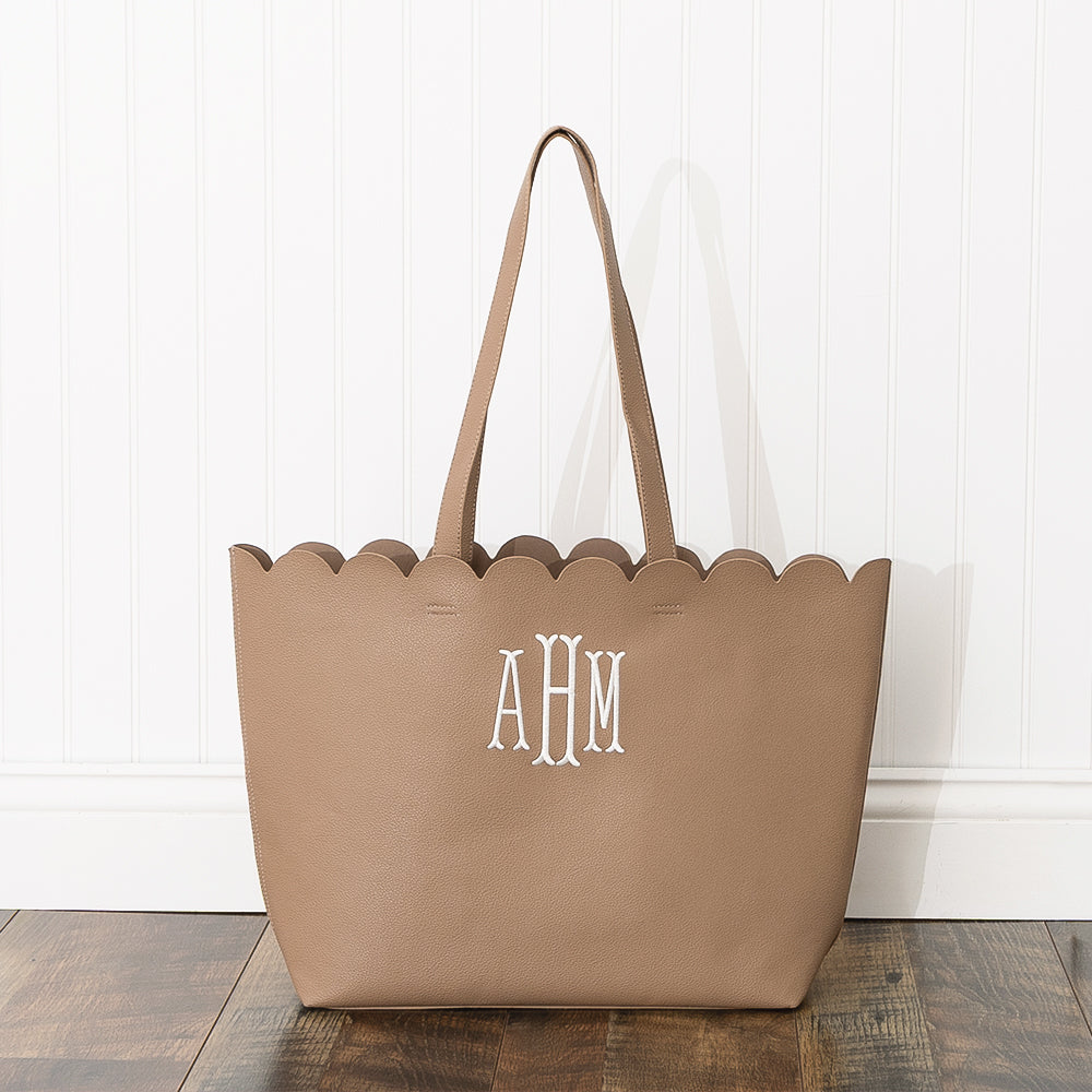 tan scallop tote bag with white wall