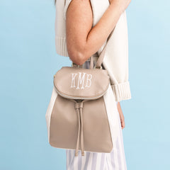taupe backpack purse on shoulder