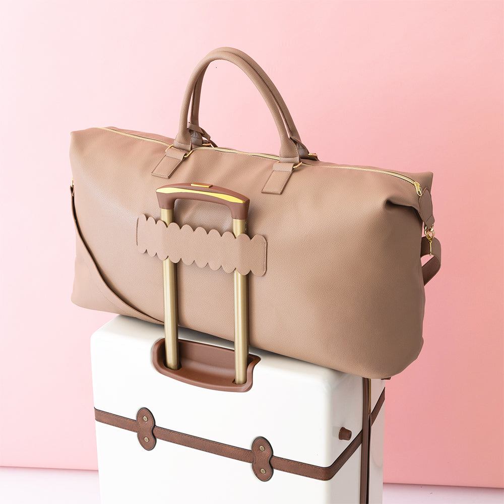 taupe classic scallop weekender on suitcase