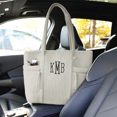 taupe grey pocket tote bag in car