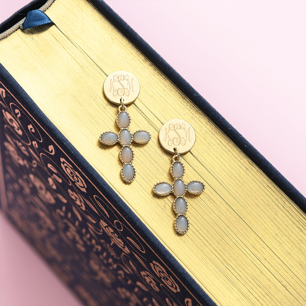 taupe monogrammed cross earrings on bible