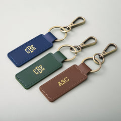trio of personalized keychains on grey flatlay