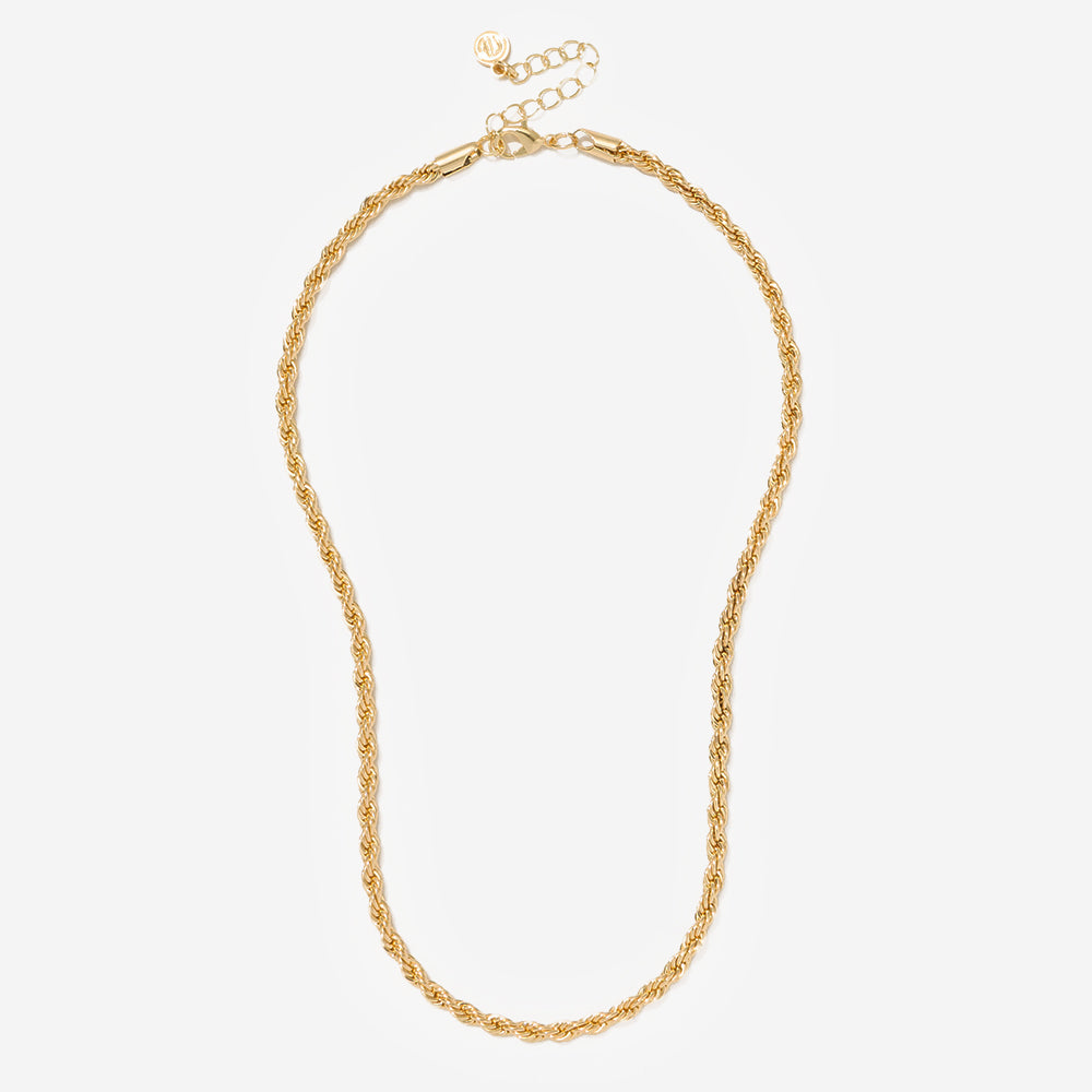 Gold necklace on a light beige background