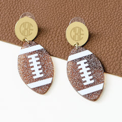 monogrammed football earrings on leather