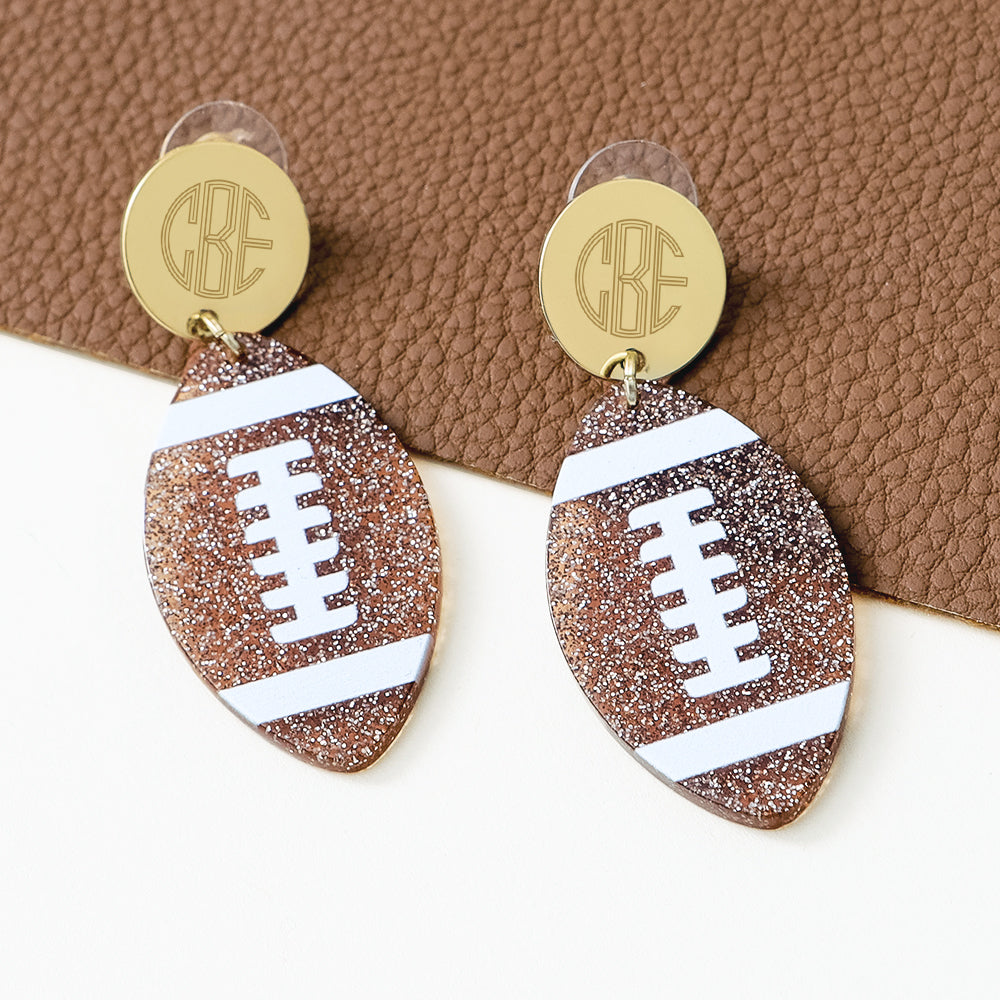 monogrammed football earrings on leather