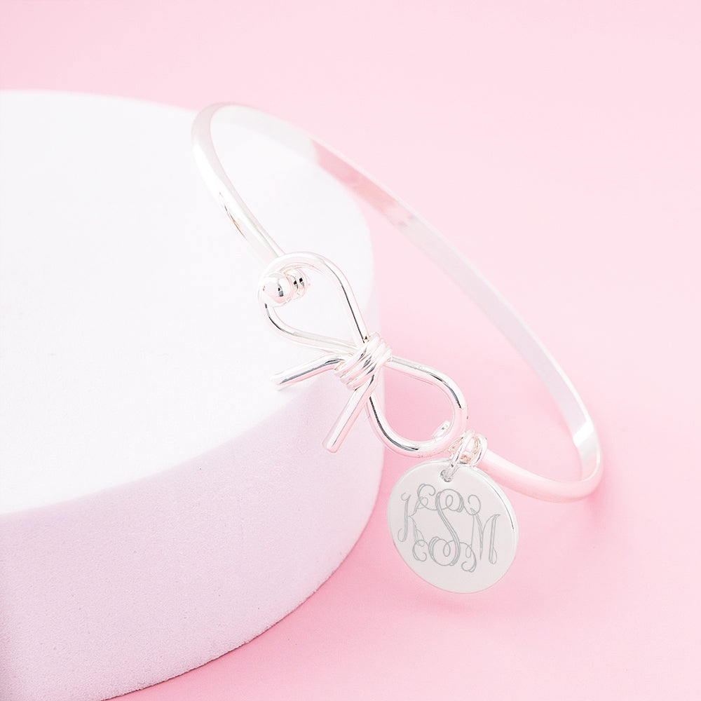 silver bow bangle on pink