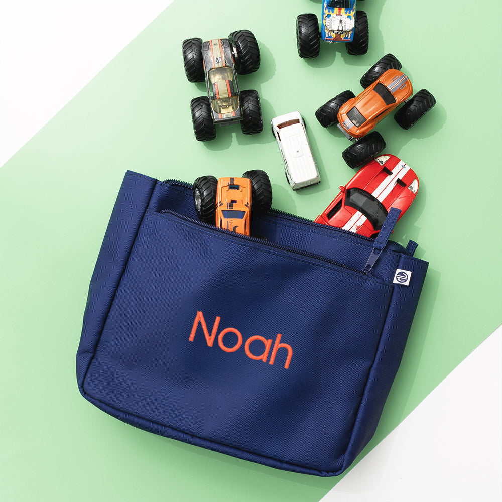 navy essentials pouch on green background