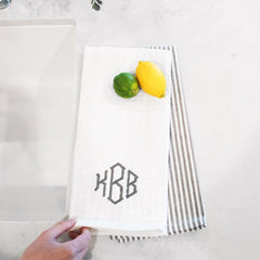 grey dish towel next to sink with lemon lime