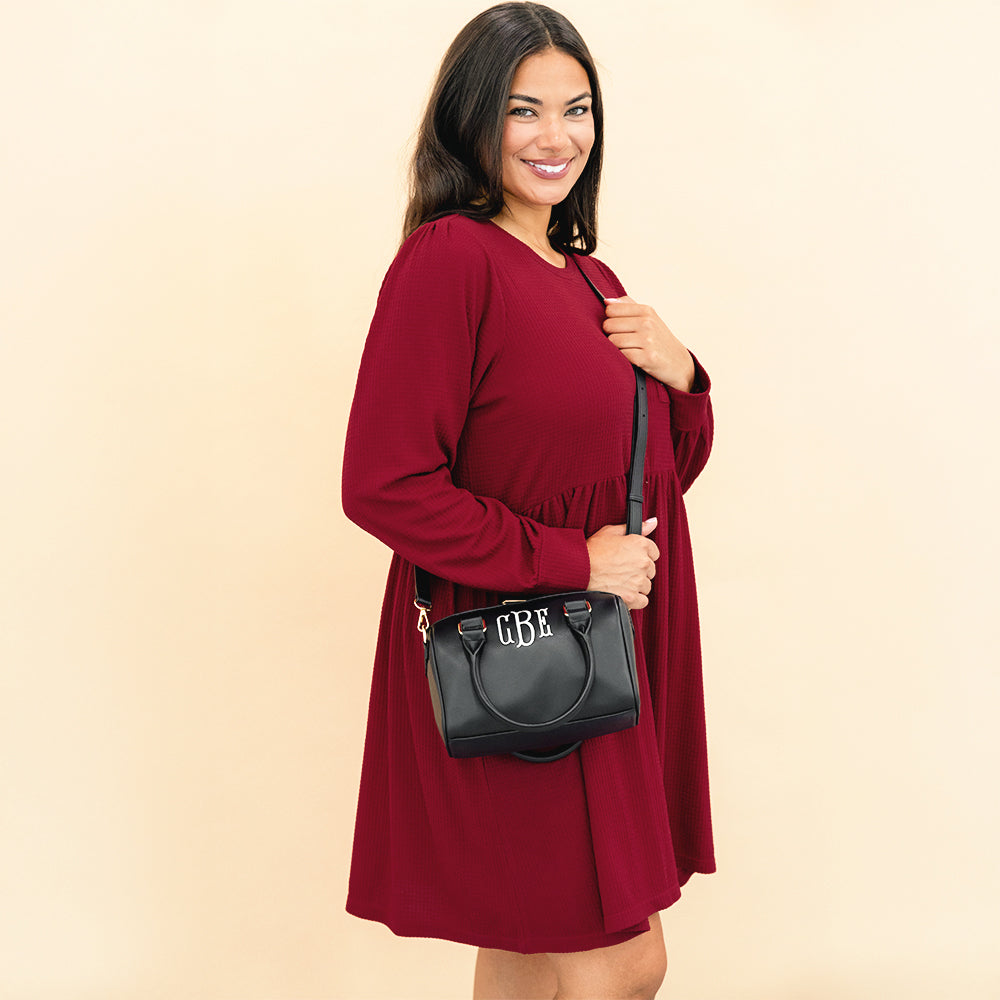 black harper handbag on shoulder