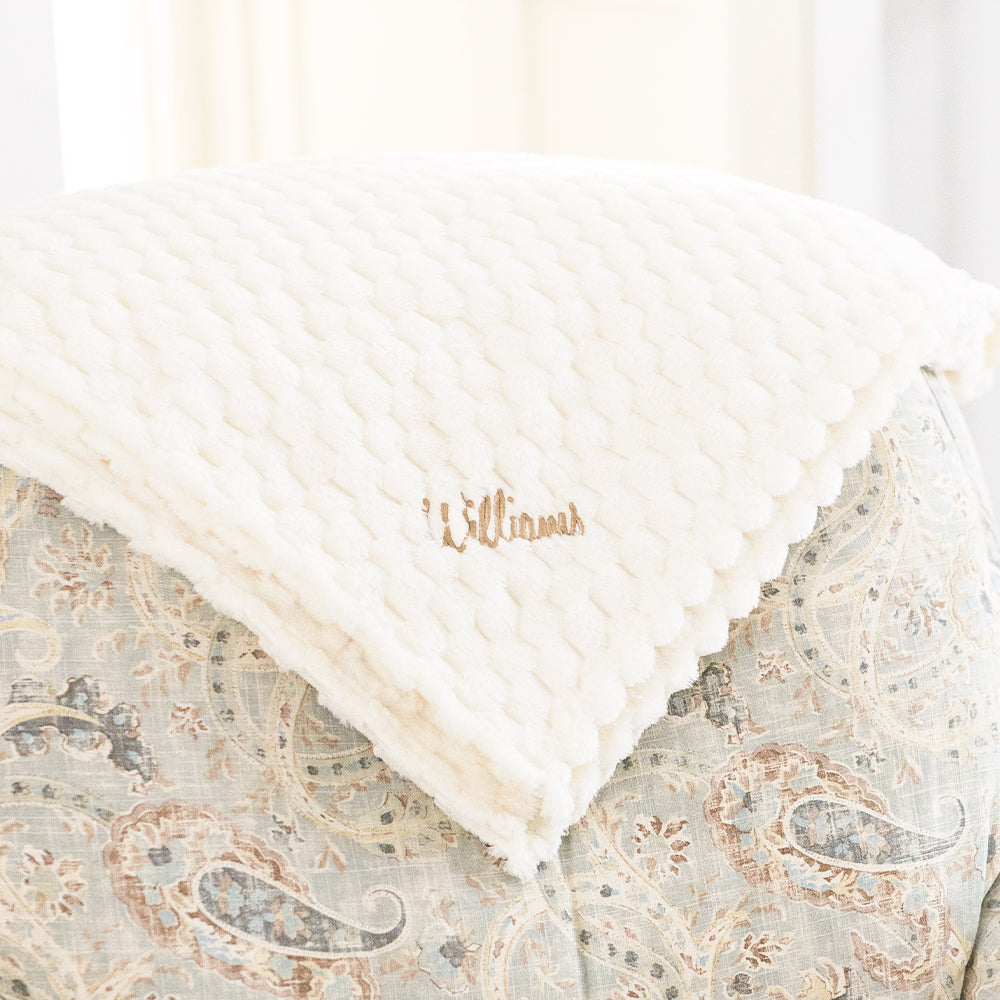 ivory textured plush blanket on chair