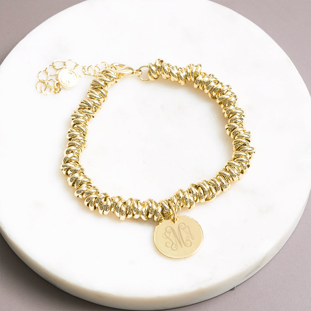 gold twisted knot bracelet on marble dish