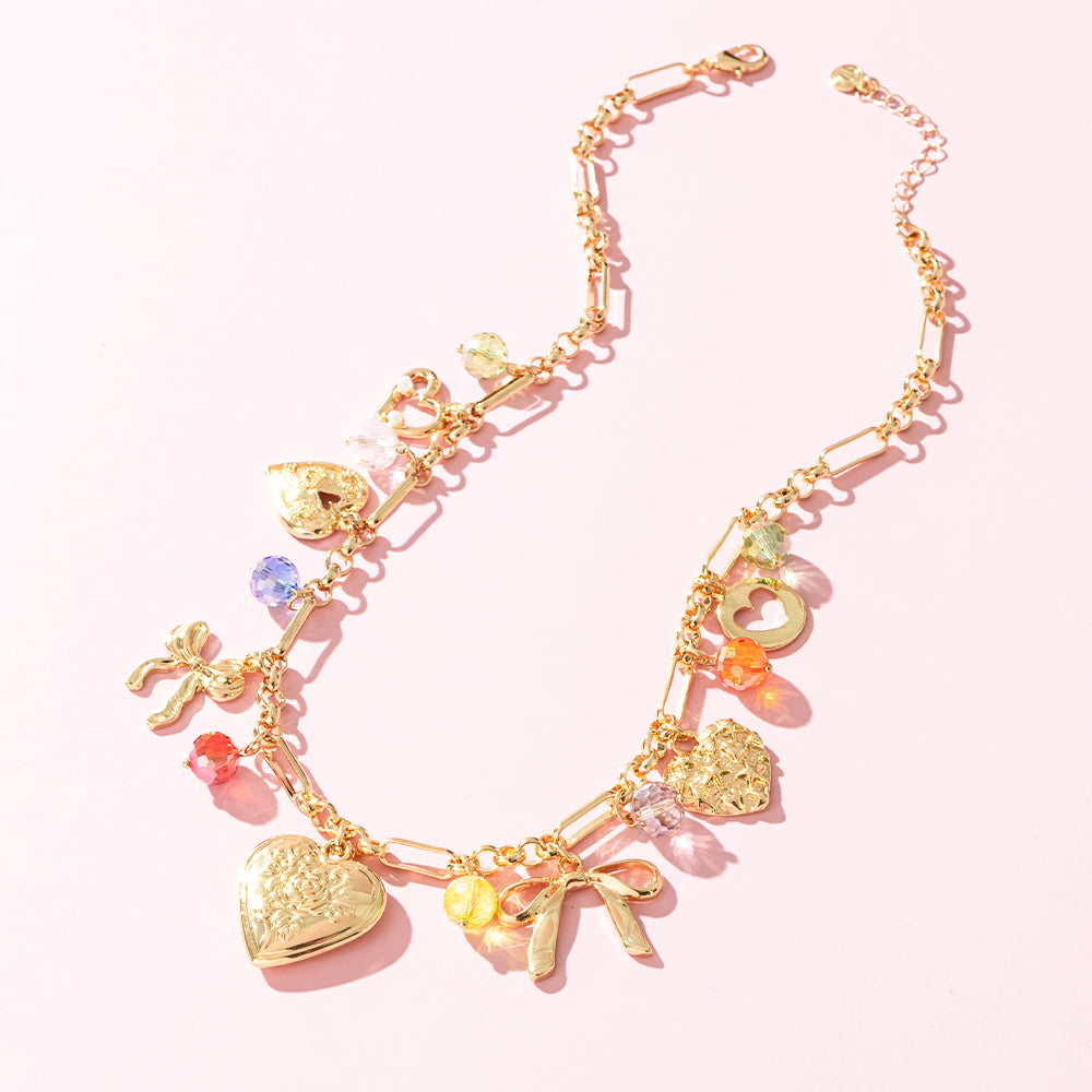 beaded charm necklace on pink background