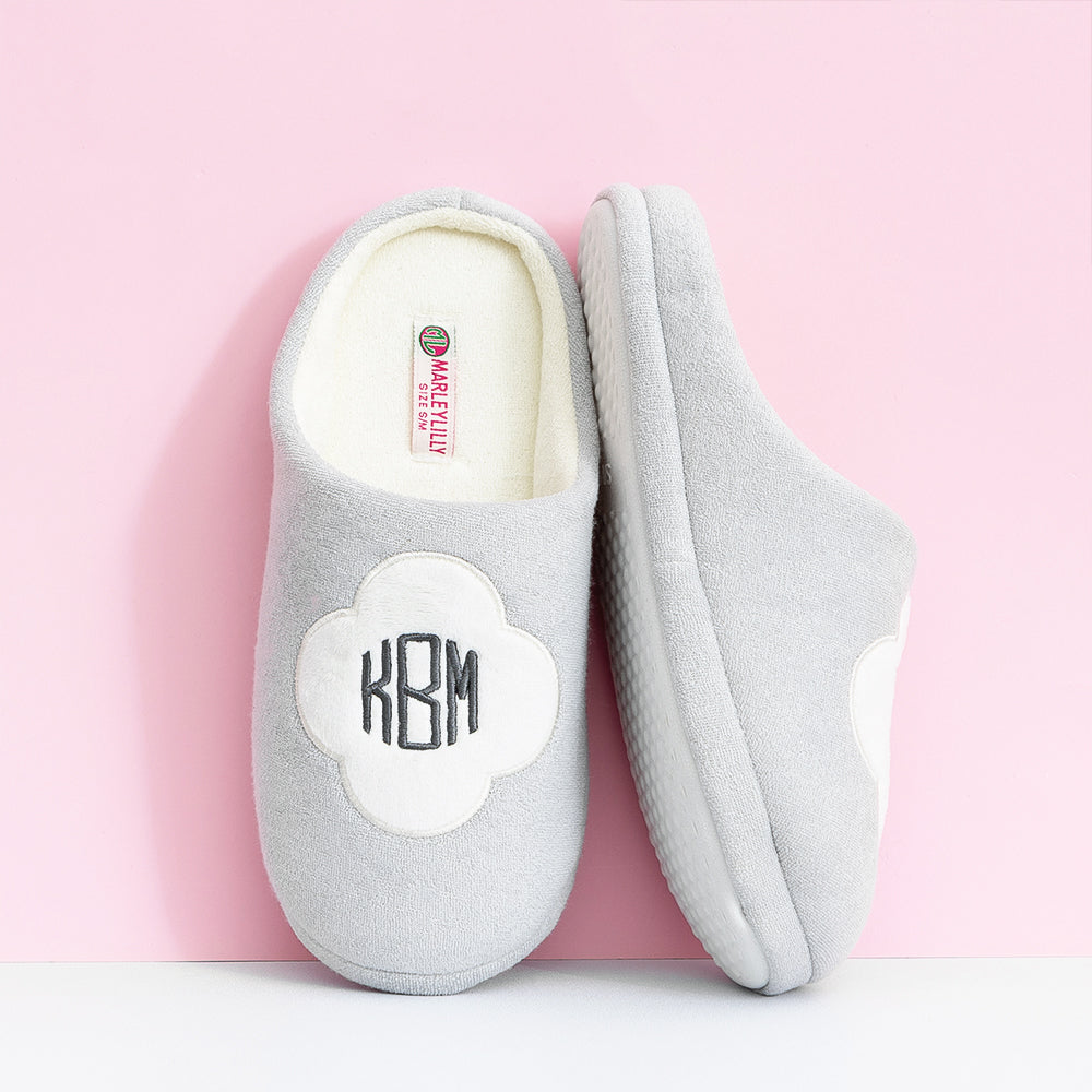 white quatrefoil slippers leaning against wall