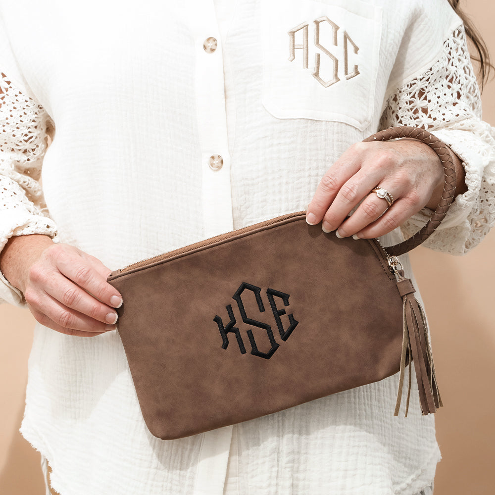 brown wristlet clutch in hands