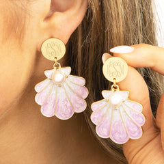 purple shell earrings in ear