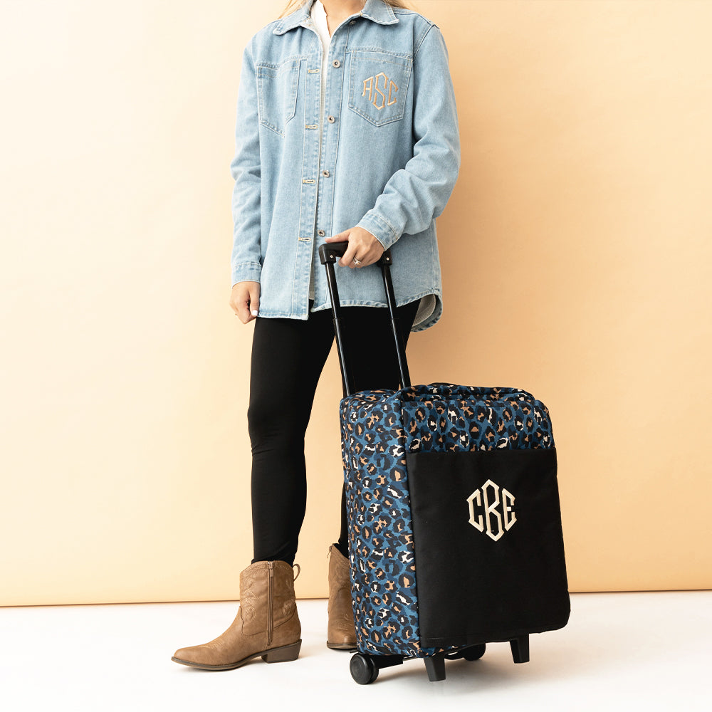 sapphire leopard rolling duffel bag in hand