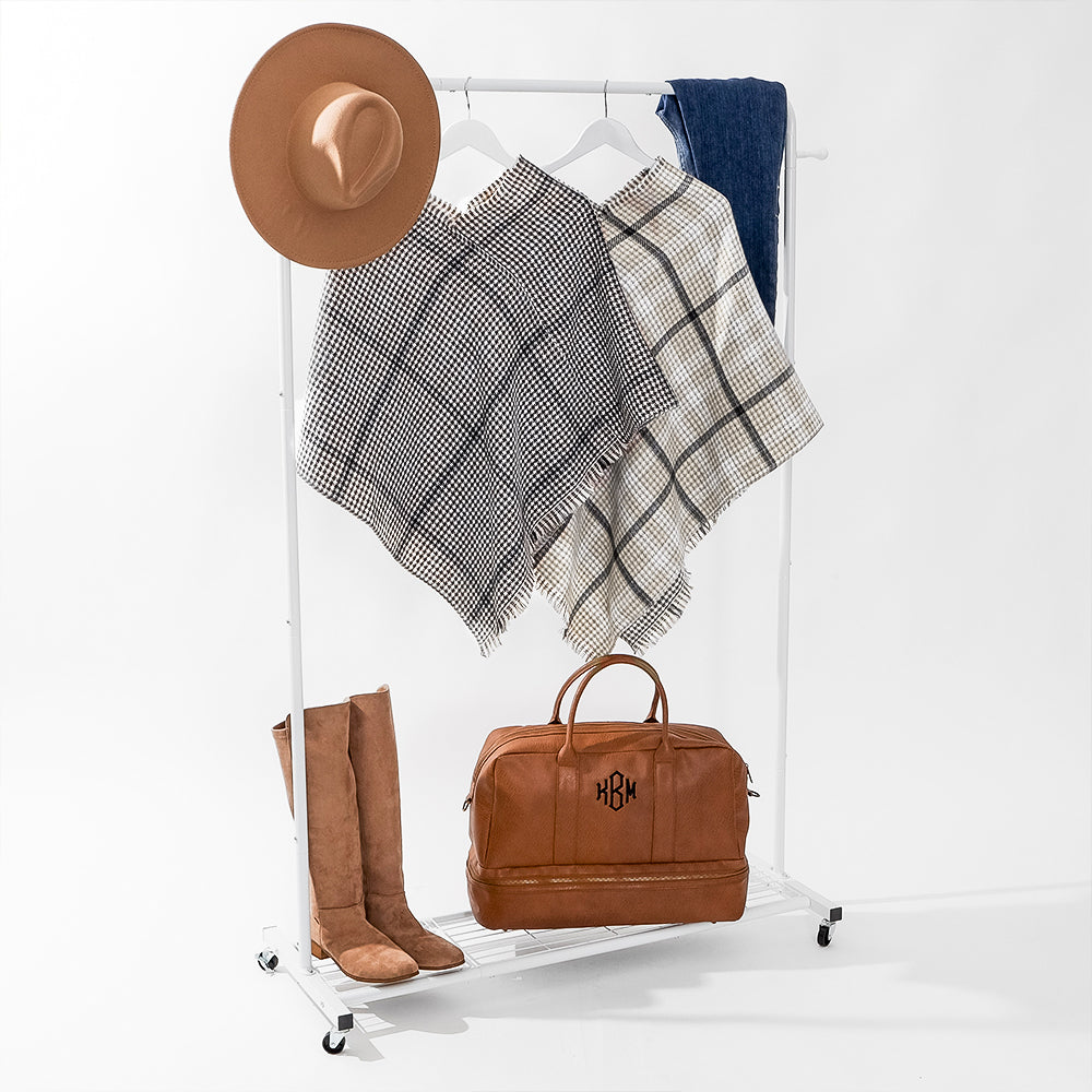 reversible poncho styled with wide brim hat, tall boots, denim and leather bag