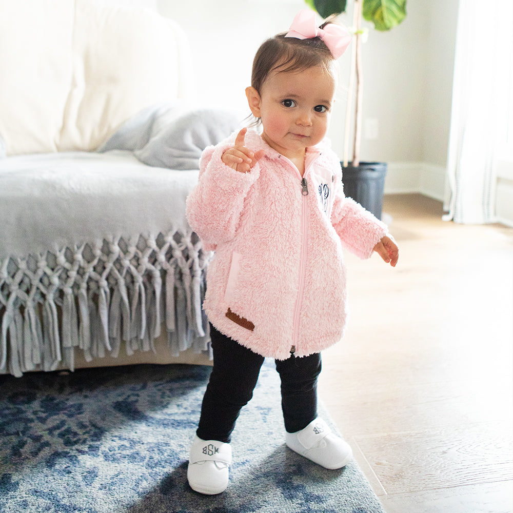 baby girl wearing ivory monogram shoes & sherpa