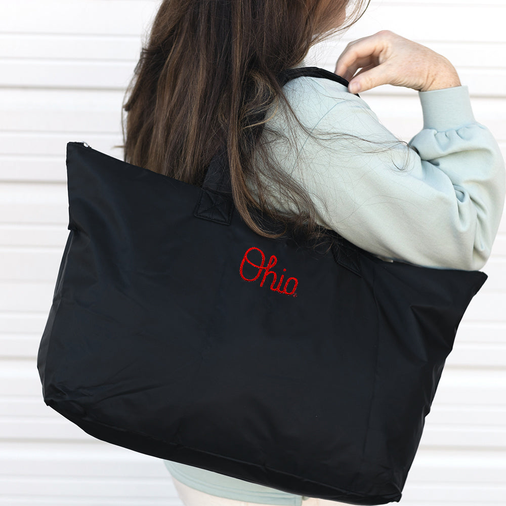 black ohio state packable duffel bag on shoulder