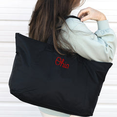 black ohio state packable duffel bag on shoulder